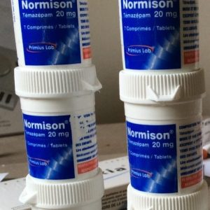 Containers of Normison Temazepam medication with clearly visible labels and milligram strength printed on them, representing prescription sleep tablets used in Australia.